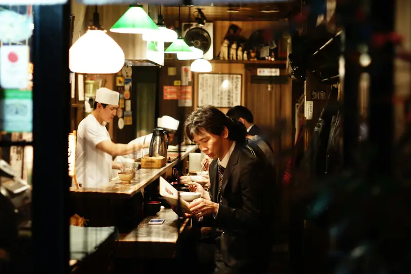 Le comptoir d’un restaurant sous des lampes chaudes.